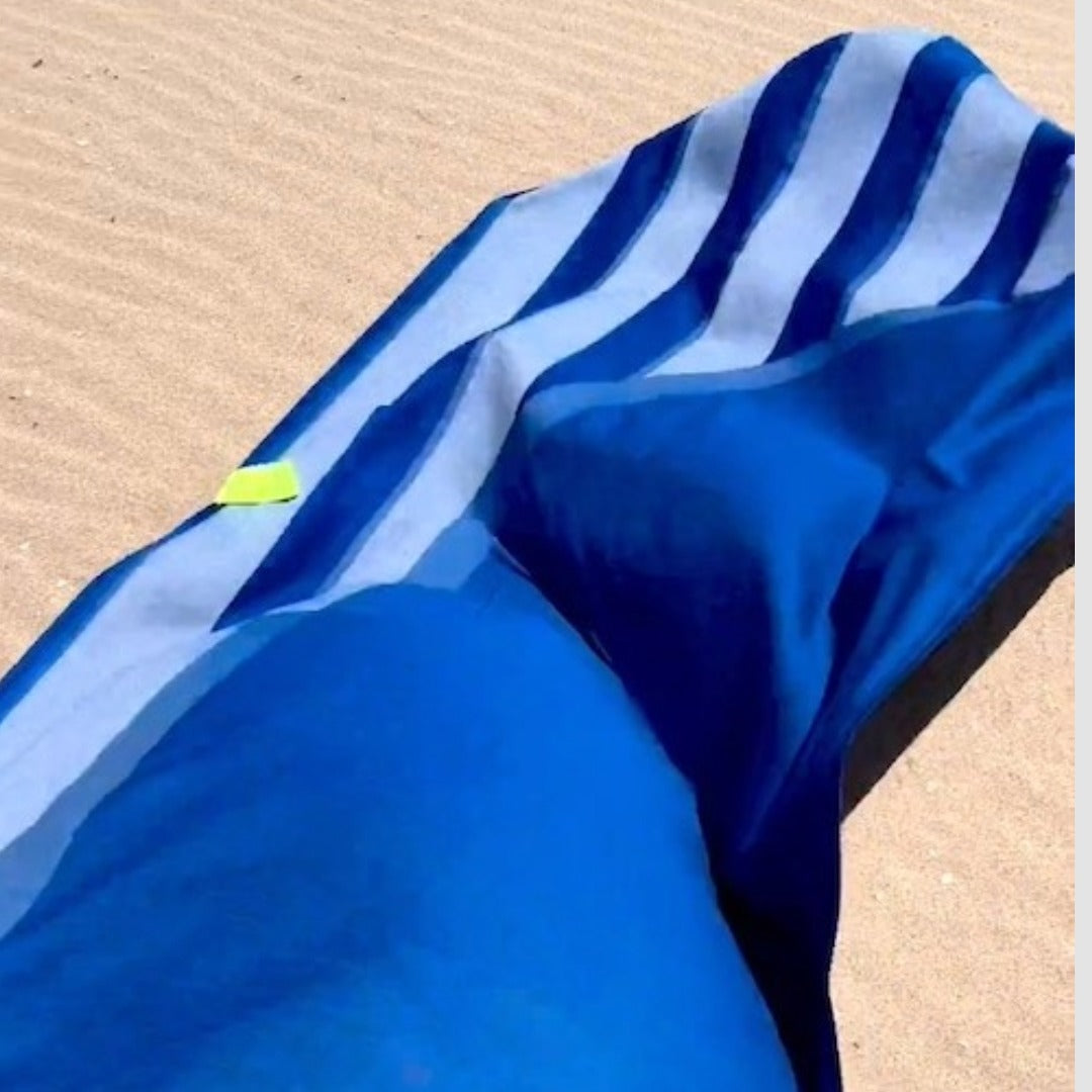 Blue striped towel on sand
