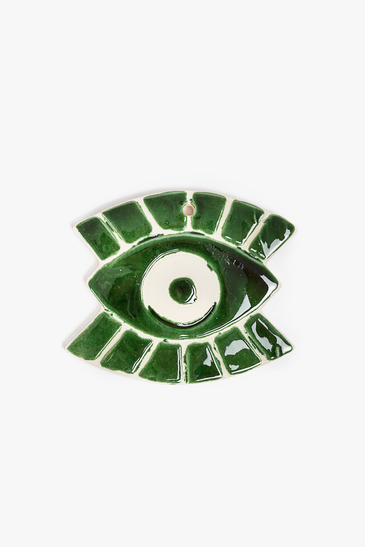 Green ceramic eye-shaped decorative ornament on a white background