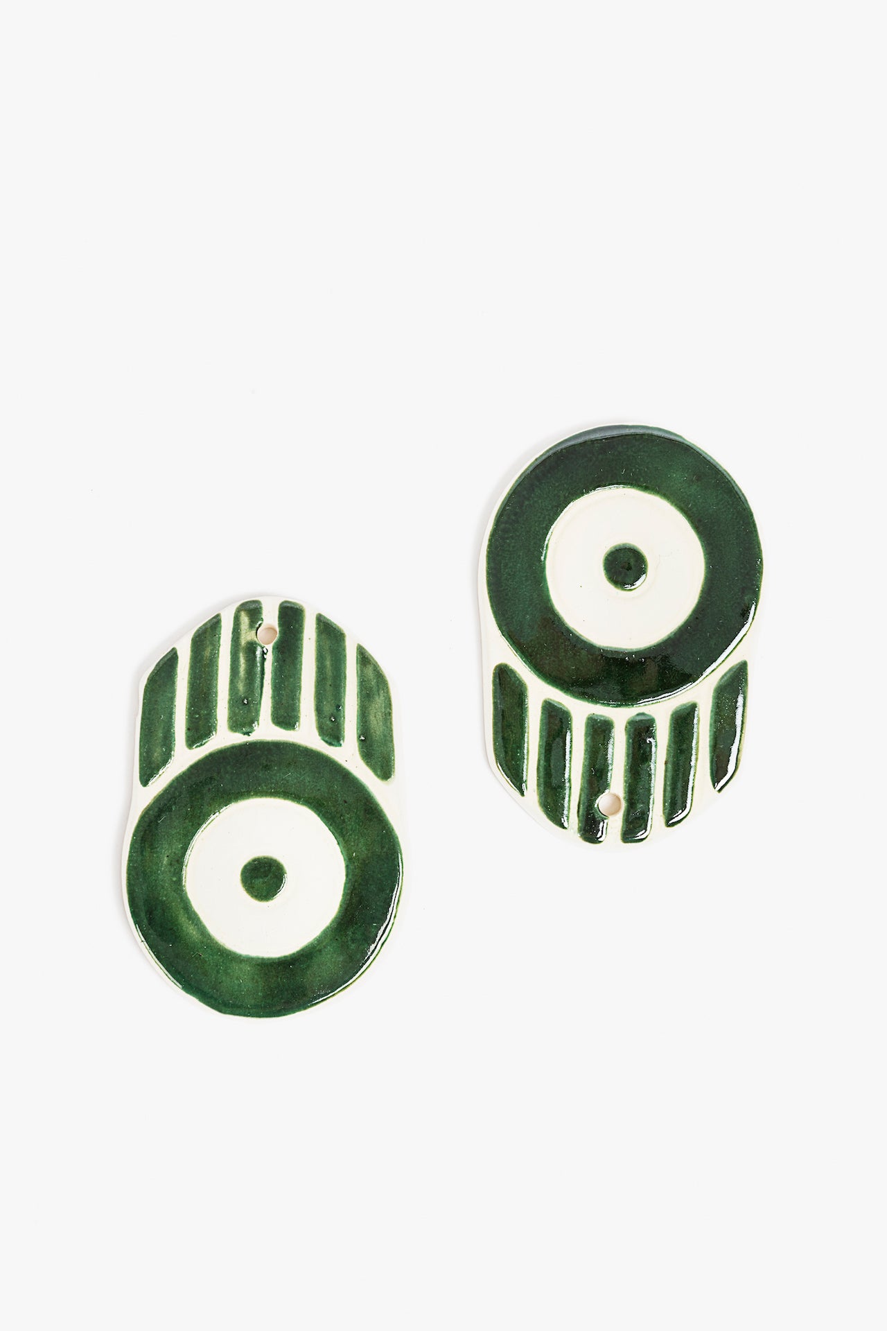 Pair of green ceramic ornaments on a white background
