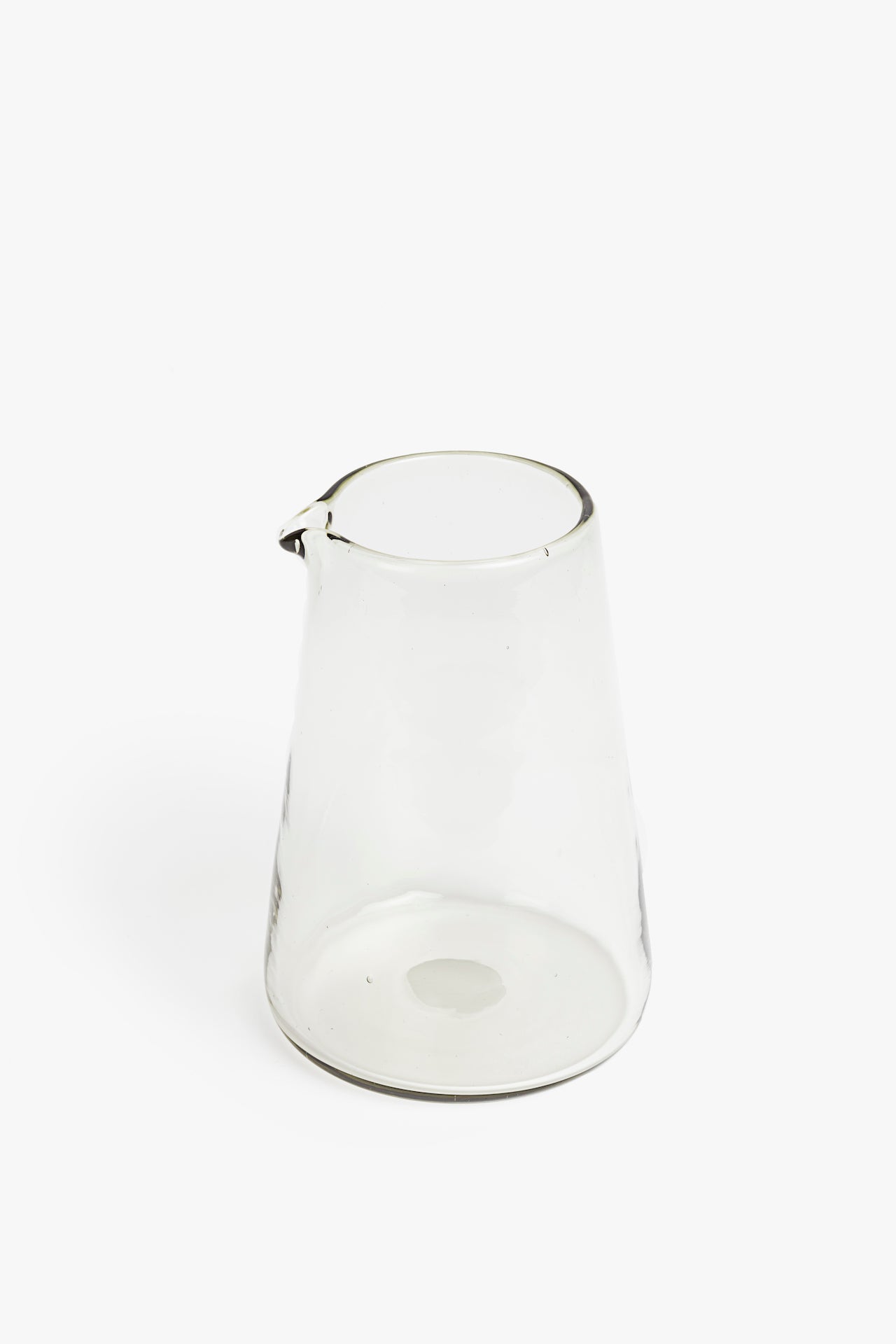 Clear glass pitcher on a white background