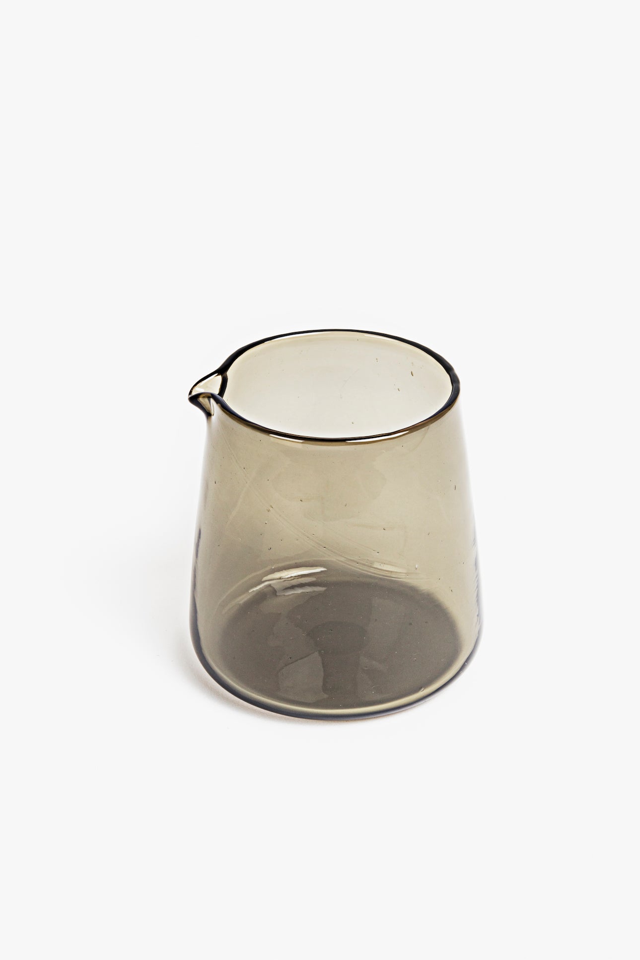 Clear blown glass pitcher on a white background