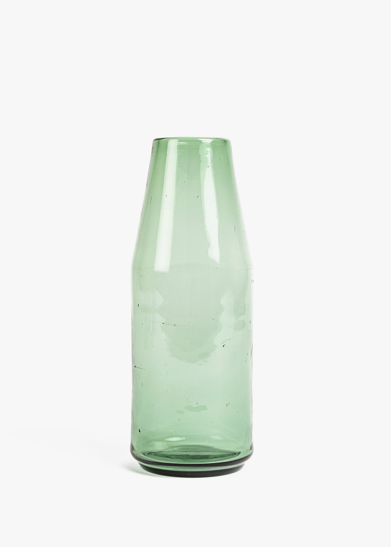 Green glass carafe on a white background