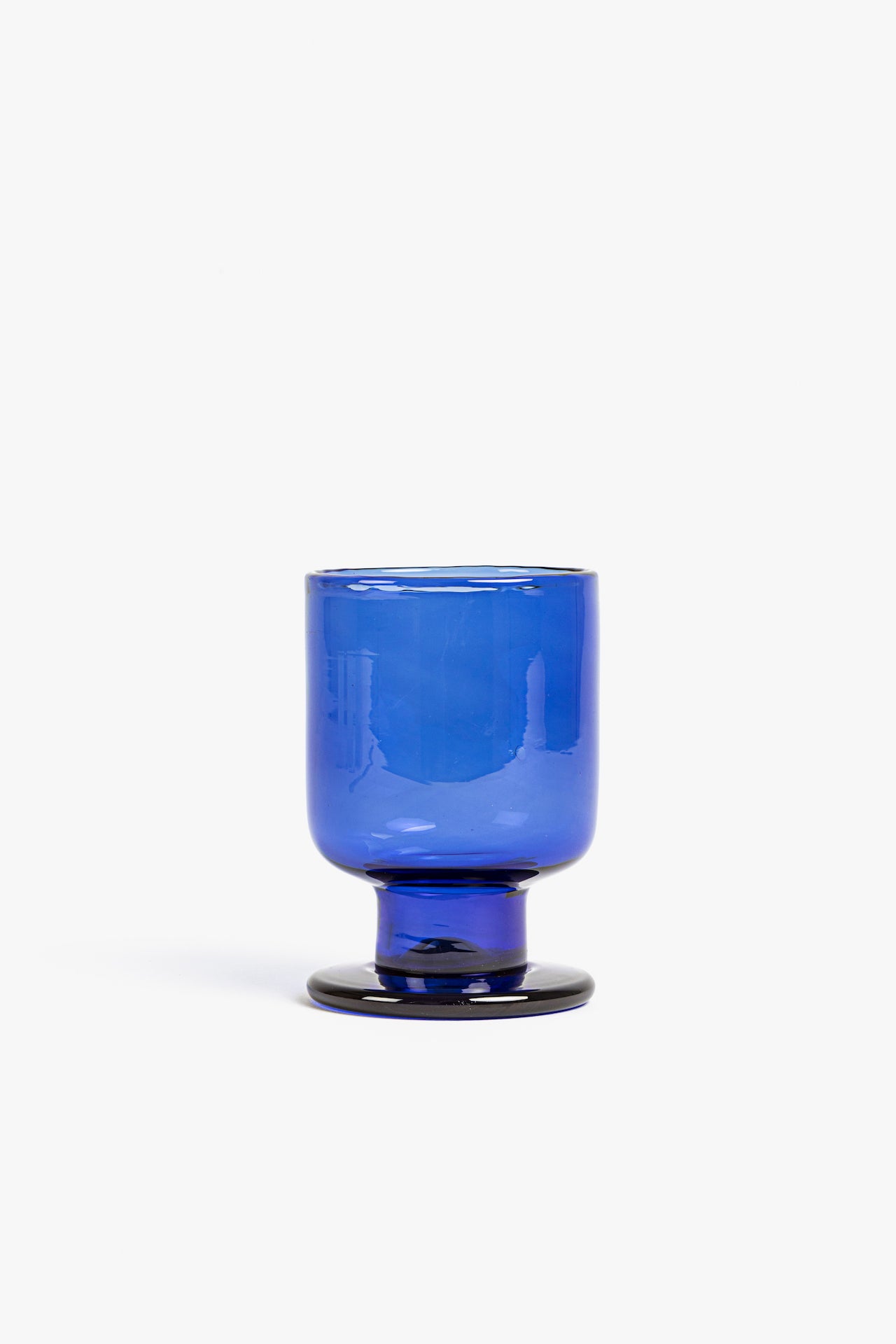 Blue blown glass cup on a white background