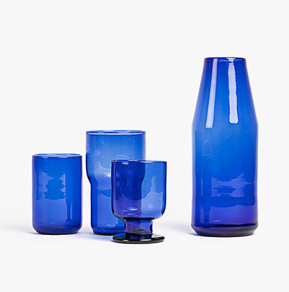 Blue glass carafe bottle on a white background