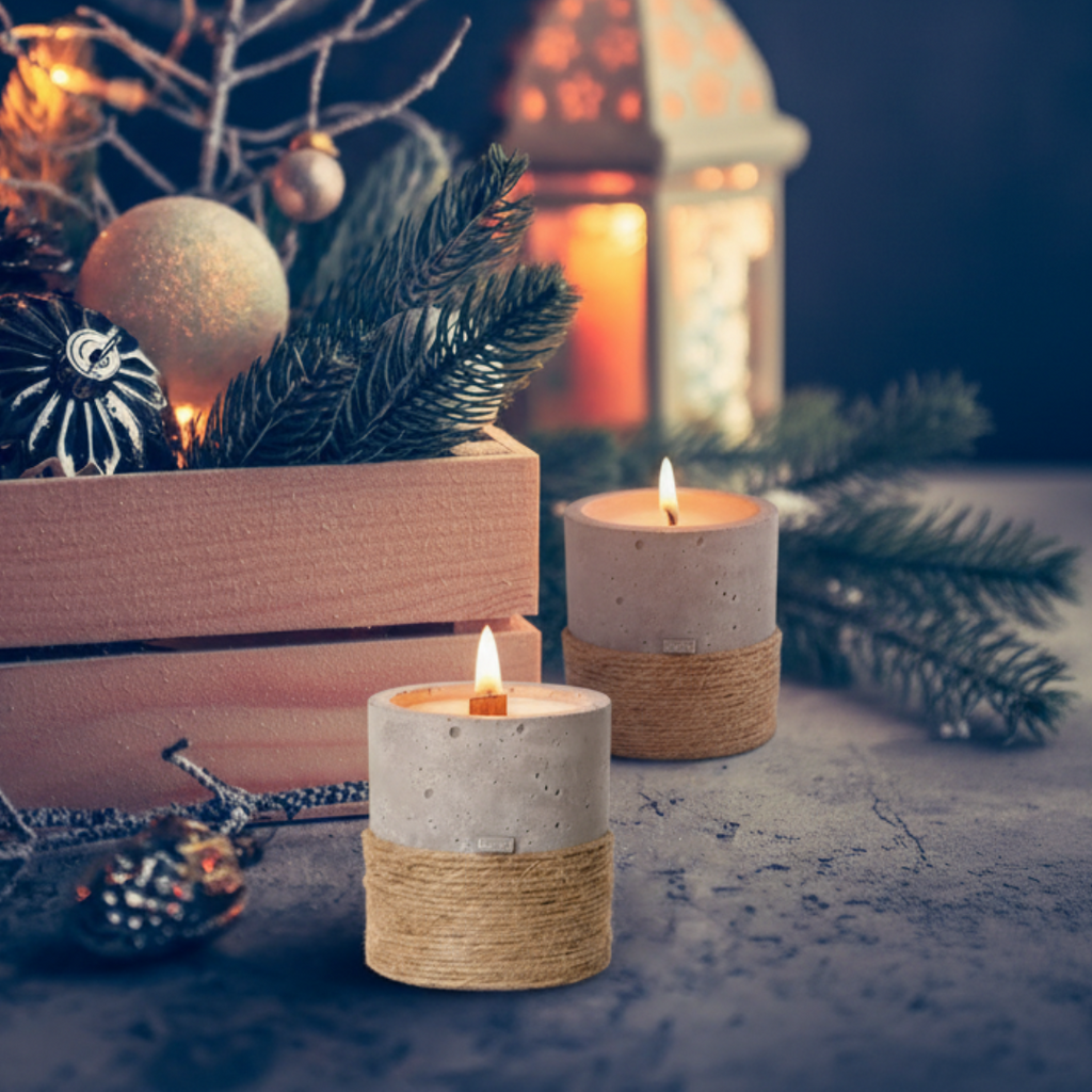 Decorative candles with a lantern and Christmas ornaments on a dark background