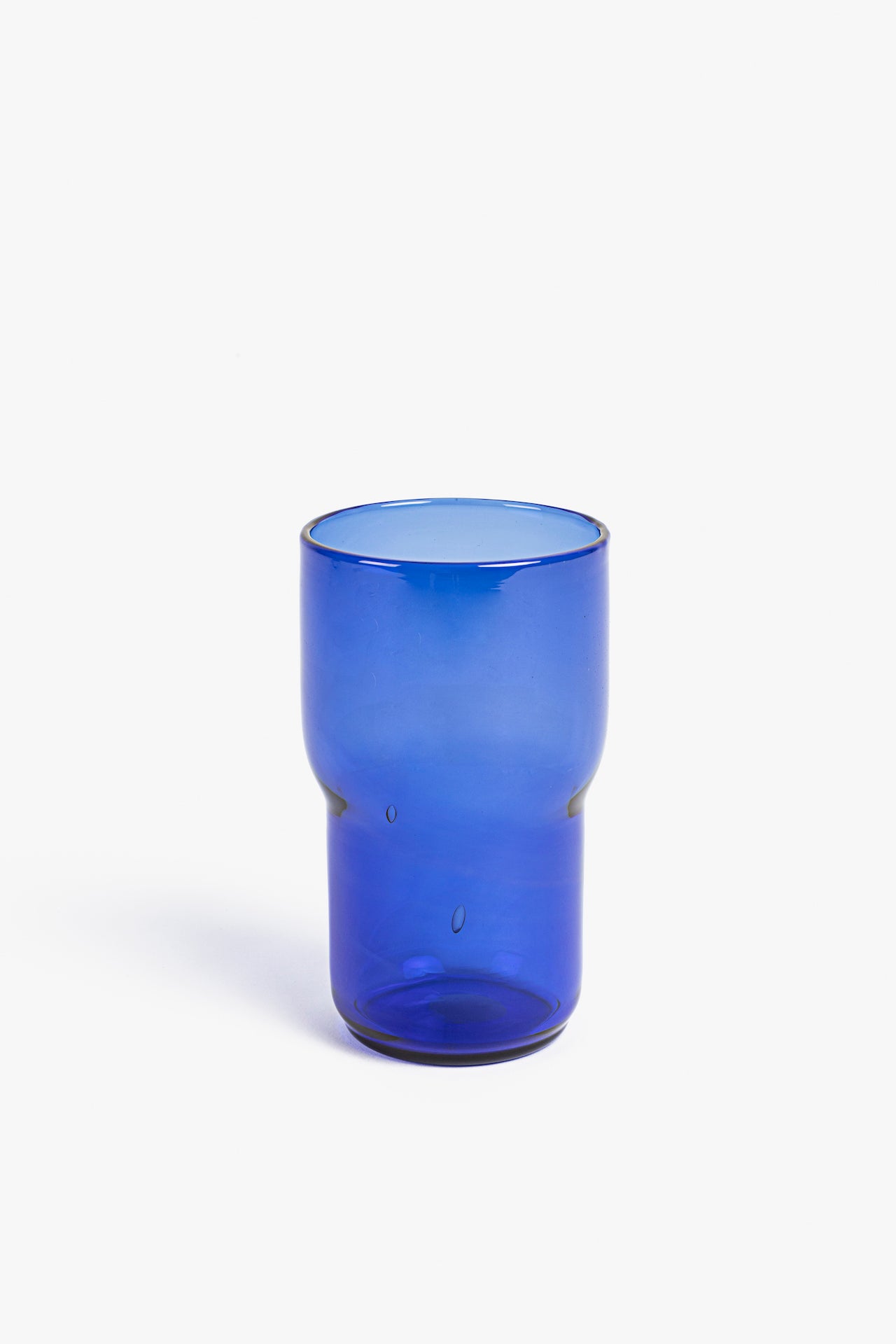 Two blue glass tumblers on a white background