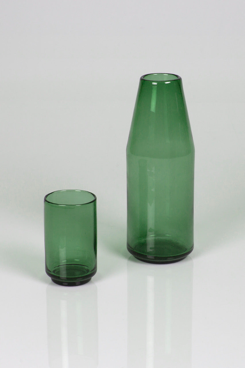 Green glass carafe on a white background